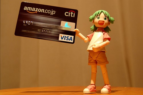 Anime doll holding VISA card