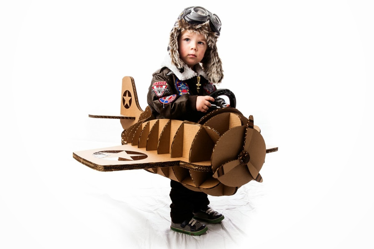 Young boy in fancy dress, playing with toy aeroplane Stock Photo - Alamy