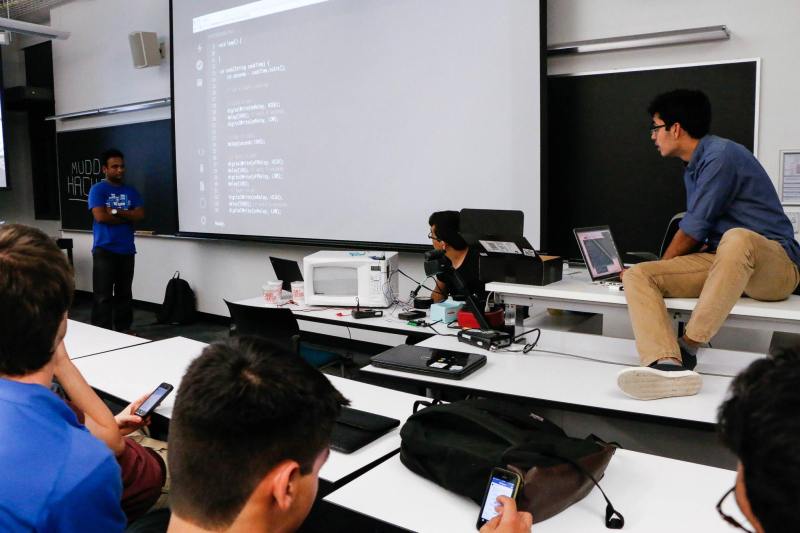 [Akhil], [Ben], and [Apoorva] bring the Phone-Microwave to life at HackWeek while users try to fire it up remotely.