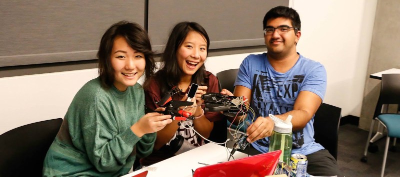 (Left to right) Erin Paeng, Cherie Ho, and Shaan Gareeb take first place by rewiring an rc helicopter for hand-control with a Leap Motion