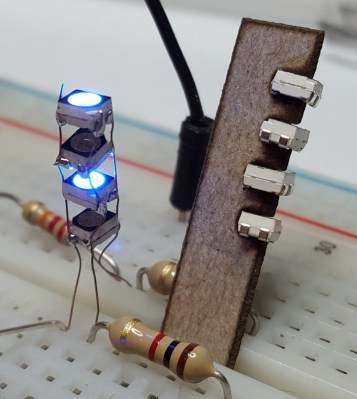 A single column of Charlieplexed LEDs. Note the resistor for scale.
