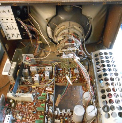 A 1972 ITT CVC5, a TV from the live-chassis era. None of the circuits you see are isolated from the mains. To the left of the big round capacitors bottom-centre is a row of dropper resistors from which lower voltages are derived.