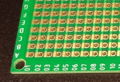 One side of a Perf+ 2 board. Each hole can selectively connect to bus next to it with a solder bridge. The bus strips are horizontal on the back side.