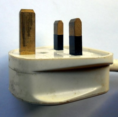 Side view of a typical BS1363 plug, showing the longer earth pin and insulated live and neutral pins.