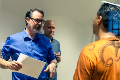 Resident Engineer Dan Hienzsch (left) answers questions in the rapid prototyping room