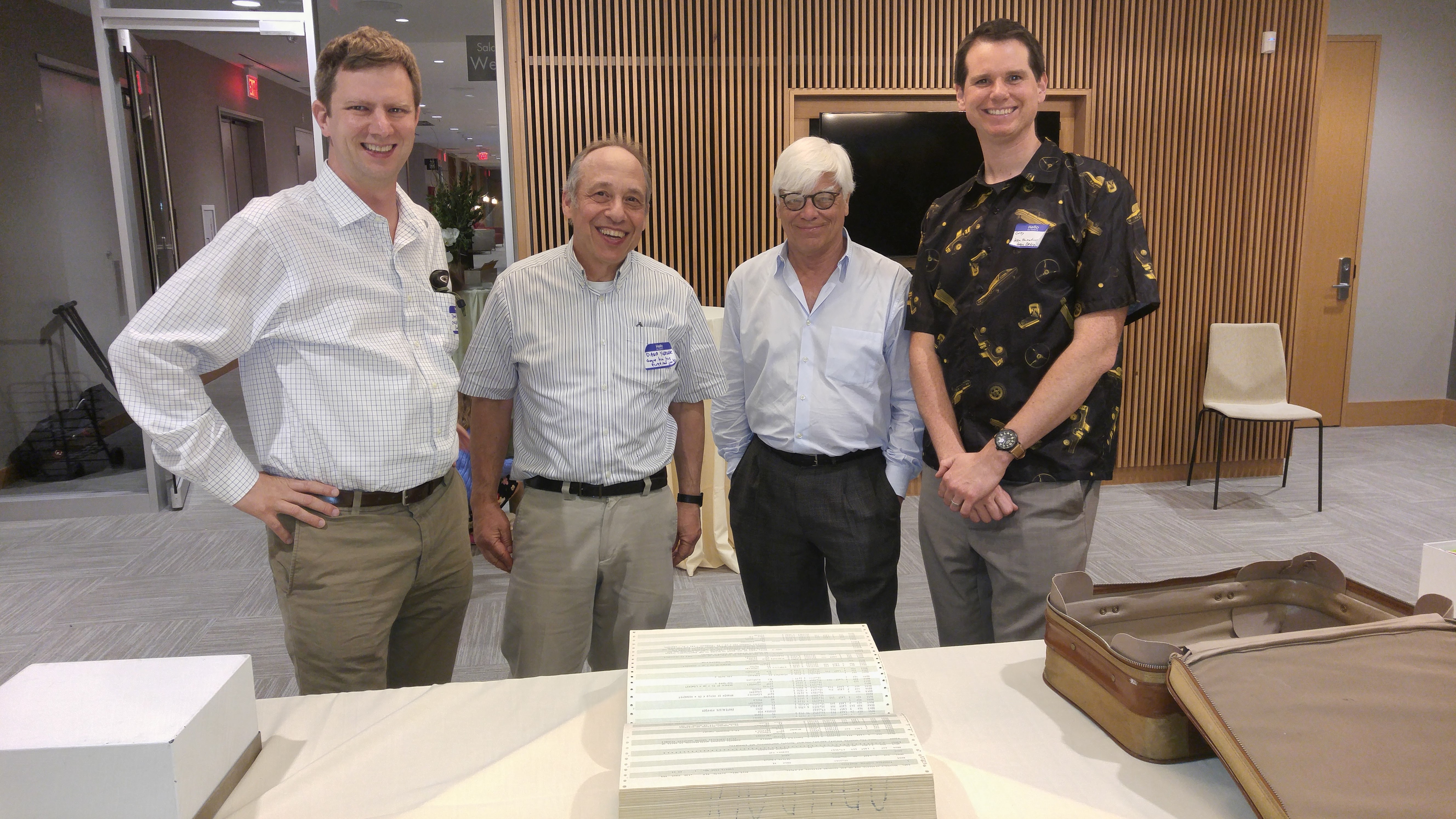 From left to right; James Kinsey, Dana Yoerger, Don Eyles, Gregory L. Charvat. In the foreground, possible the last or one of the last paper copies of the Lunar Module source code.