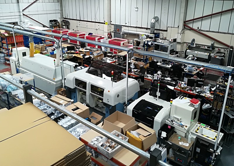 The Pimoroni shop floor. Across the centre is the reflow line, against the back wall are the laser cutters.