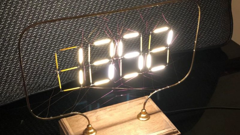 Old LED Light Bulbs Give Up Filaments For Spider Web Clock | Hackaday