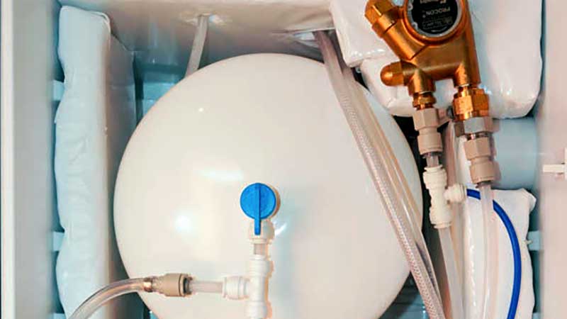 inside shot of a refrigerator with water bulk tank and seltzer pump