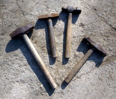 An array of hammers of different weights and types.