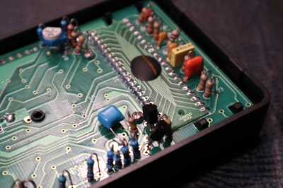 An ICM7106 epoxy blob on a 40-pin DIP-shaped PCB