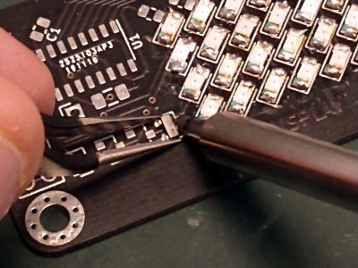 Soldering in close-up, a phone camera view.