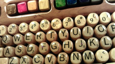 wooden keyboard with Scrabble tiles