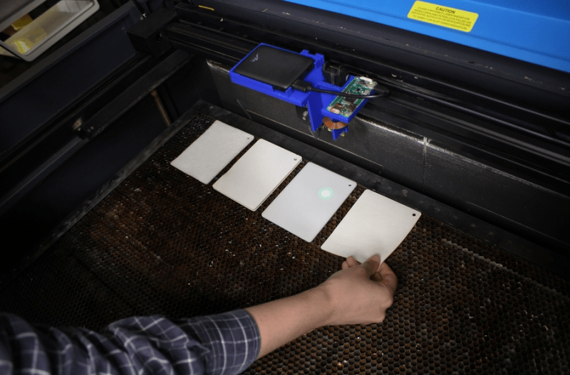 Squares of sample materials placed on the laser bed awaiting the sensing head