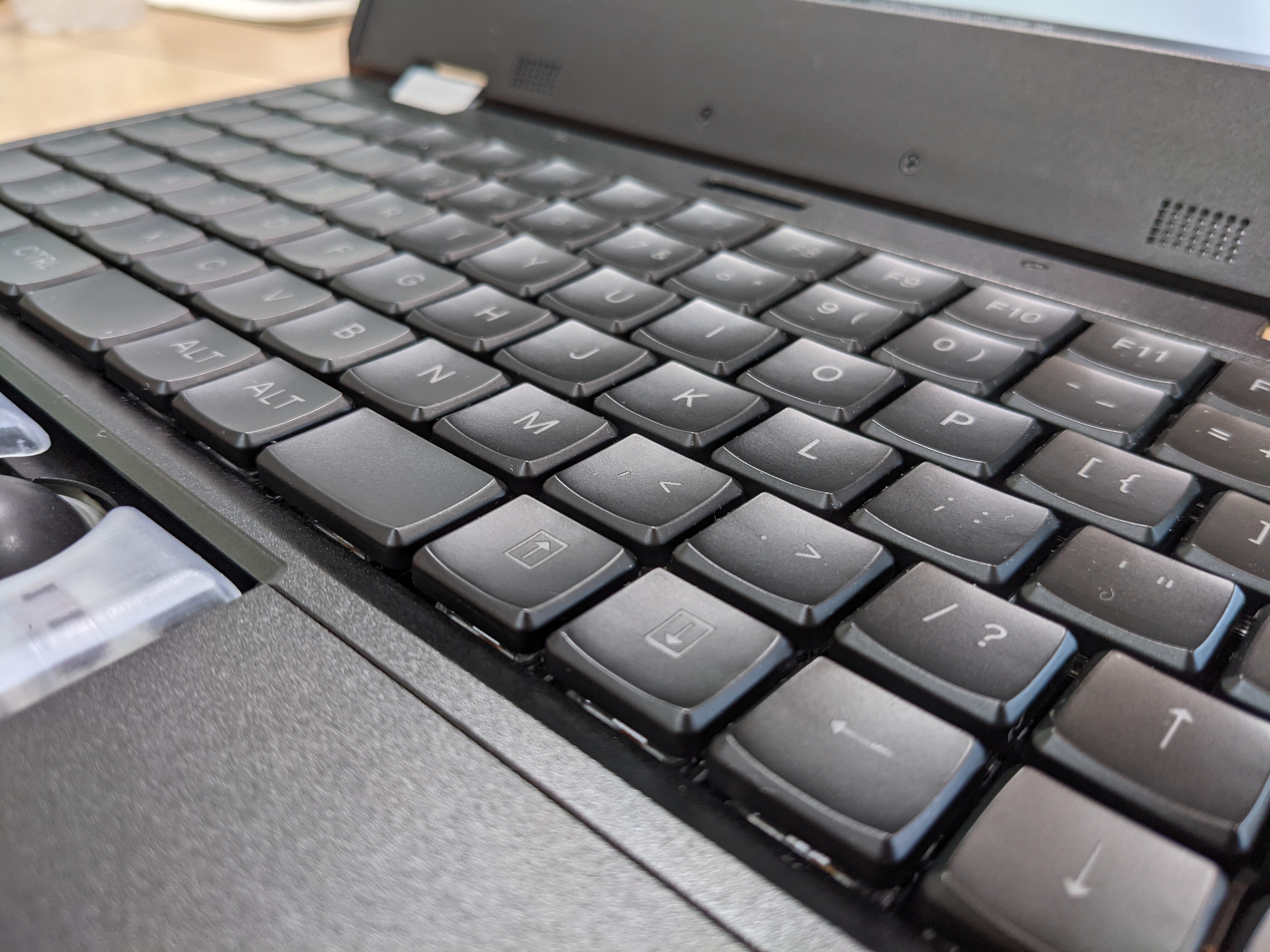 a laptop keyboard with key caps which have a deep depression in the center