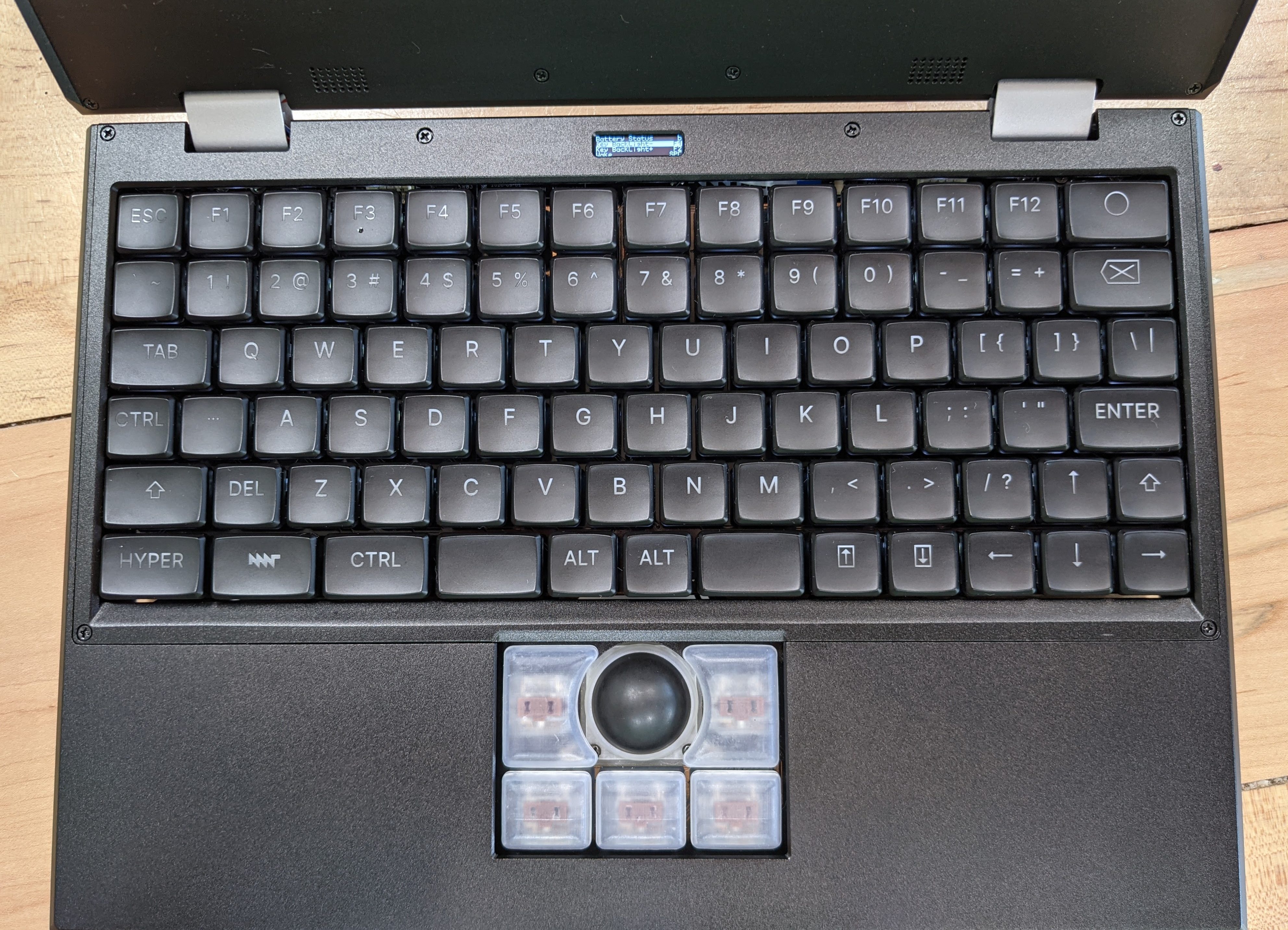 a top down view of a laptop showing the keyboard and track ball