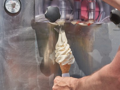 A big helping of soft serve being dispensed into a cone