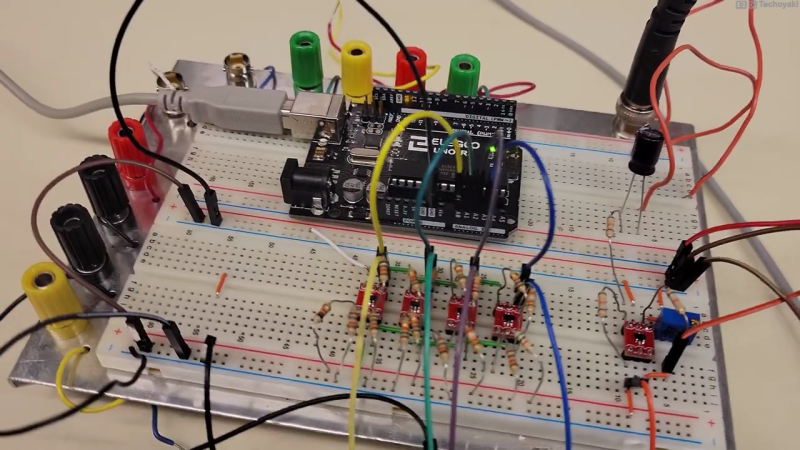 Photo of a prototyping breadboard with an Arduino, whose analog inputs are connected to an array of four small op-amp circuits which perform the voltage slicing function of the Quantizer circuit described in this article.