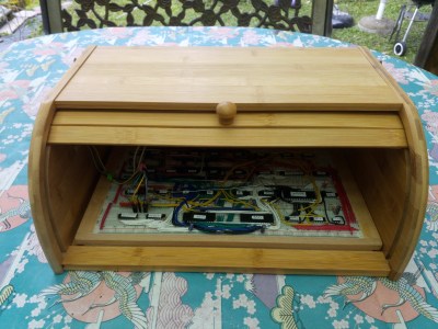 A breadboard computer inside a wooden bread bin