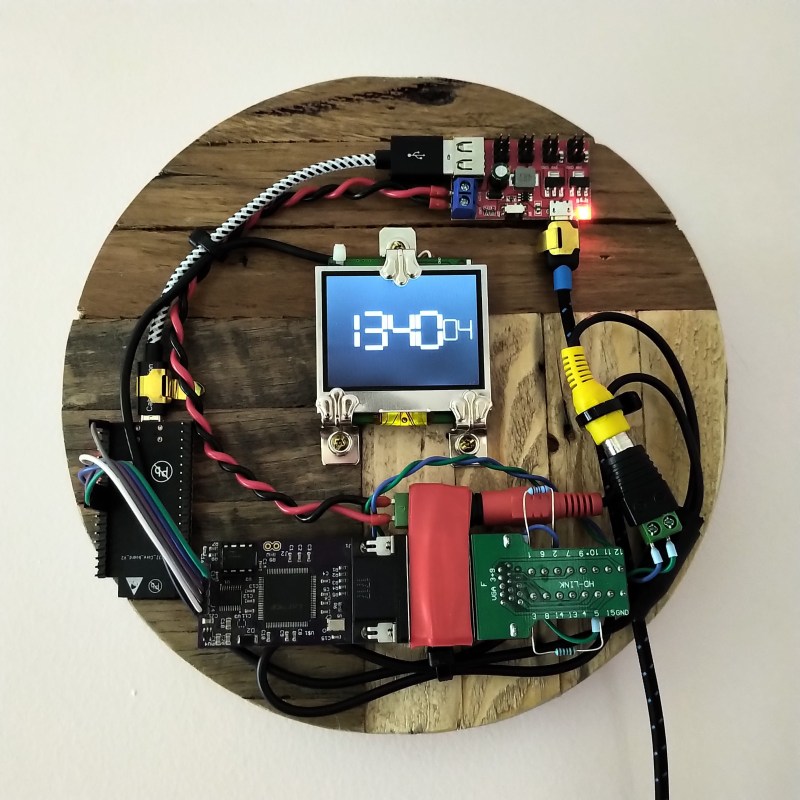 A wall clock with exposed circuit boards