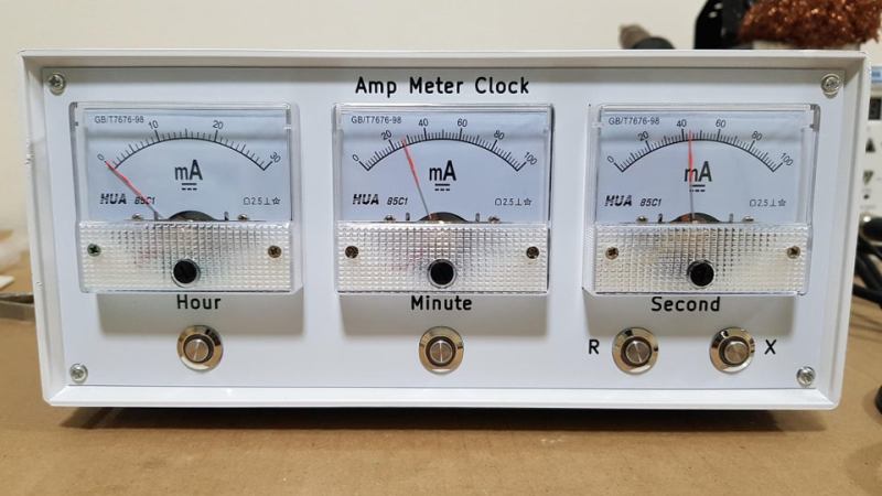the 3 needle ammeters that make up the face of the clock