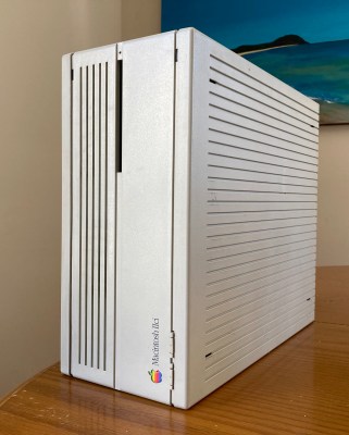 An Apple Macintosh IIci computer standing on its side