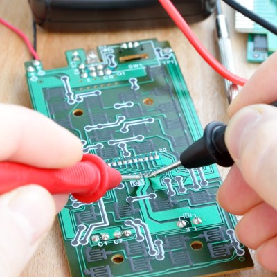 Probe a printed circuit board with a multimeter