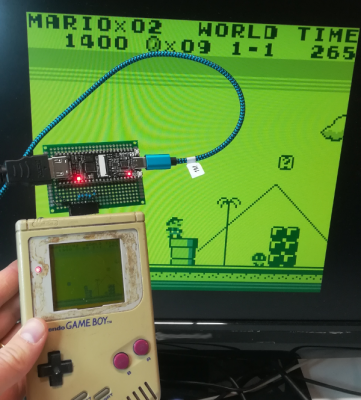 A Game Boy connected to a monitor while playing Super Mario Land 2