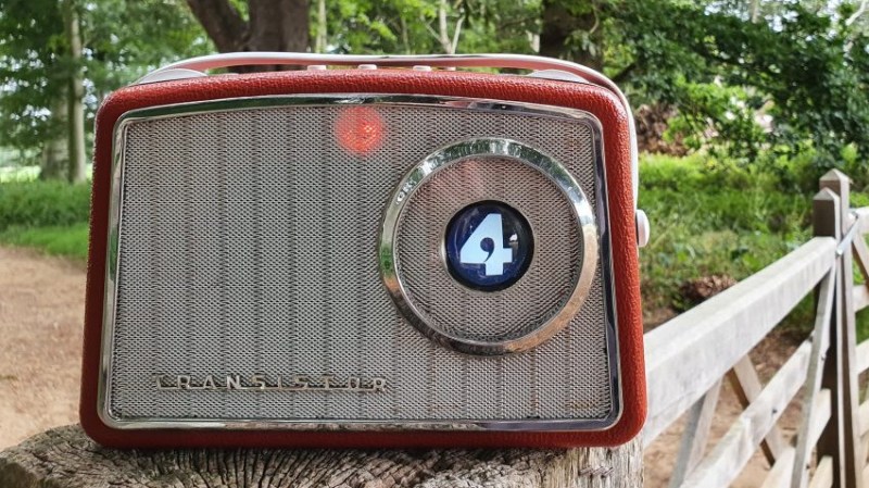 Front view of vintage radio, with small screen inset into tuner.