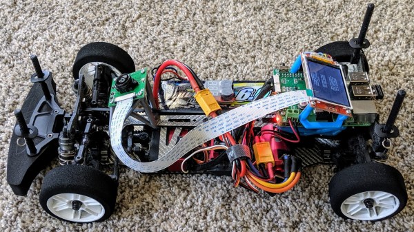 RC car without a top, showing electronics inside.