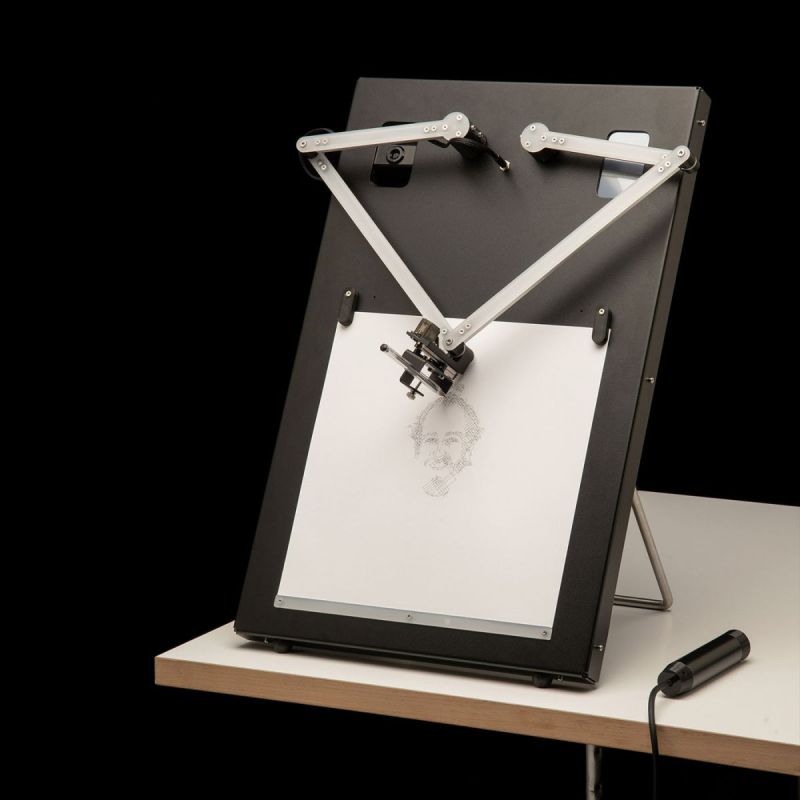 A portrait-drawing robot on a table