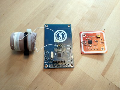 A pair of cheap NFC reader modules. The one on the left has been modified to provide resonance at 13.56 MHz.