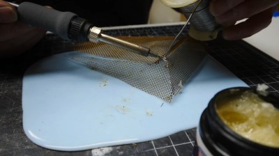 Soldering brass screen into a mold.