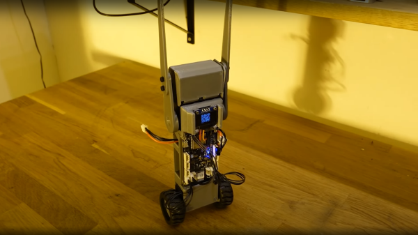 Self balancing wheeled robot with auto-righting arms lofted high