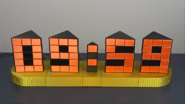 An orange 3D printed four digit clock with rotating segments