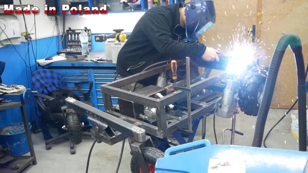A man welds on a chassis