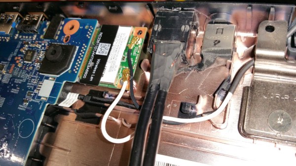 A PoE adapter's RJ45 jack added inside an Acer laptop