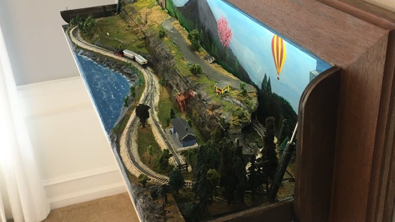 N-scale model railroad hidden in wall art