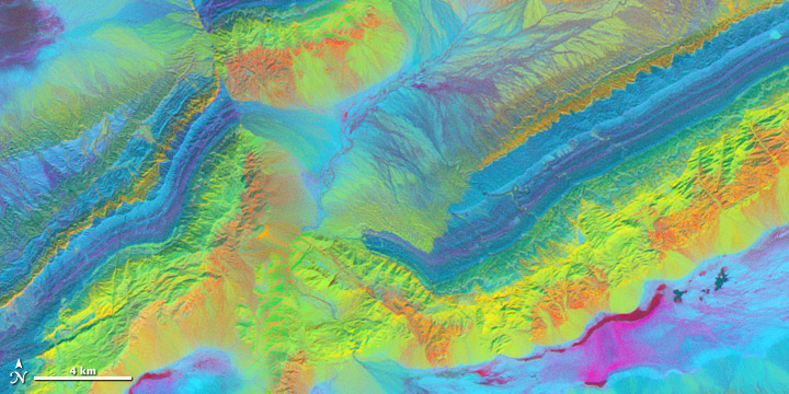 Comparing the differences between 3 shortwave infrared bands highlights the mineral geology surrounding China’s Piqiang Fault. (NASA image by Robert Simmon with ASTER data.) 