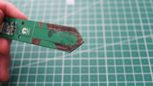A soil moisture sensor with silkscreen chipped and copper corroded