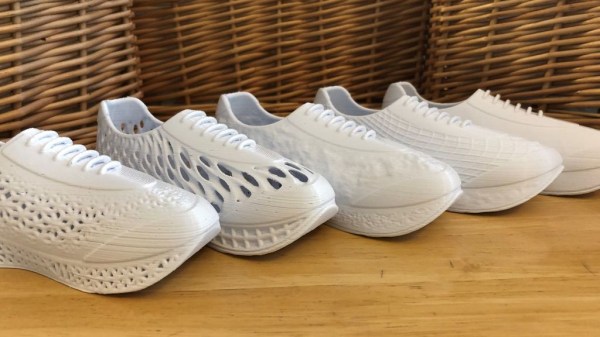 Row of white 3D printed shoes in different styles