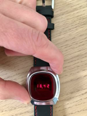 A vintage LED watch displaying "16.42"