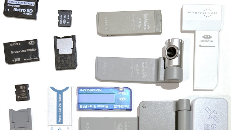 An assortment of MemoryStick cards and devices, some of them, arguably cursed, like a MemoryStick-slot-connected camera.