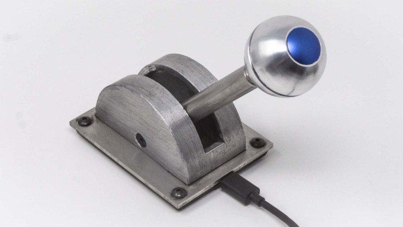 A metal spaceship throttle replica with a spherical knob