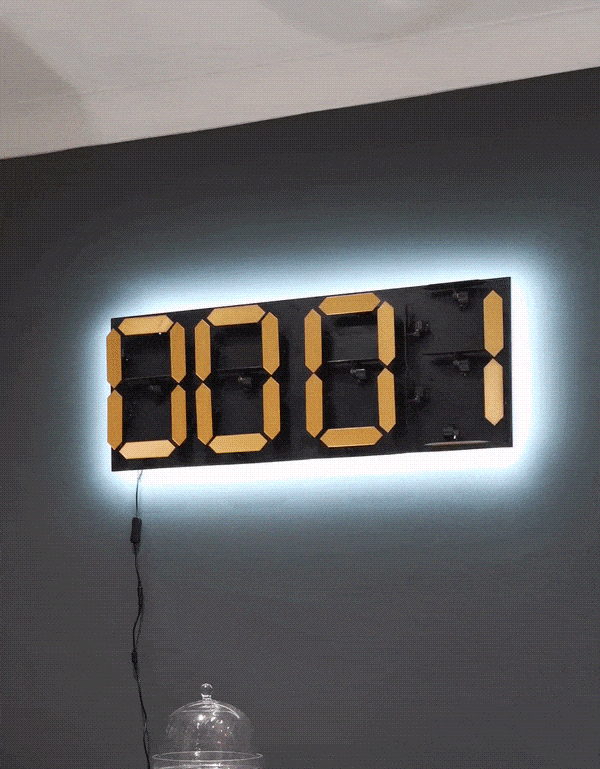 An electromechanical wall clock that shows random words when a button is pressed