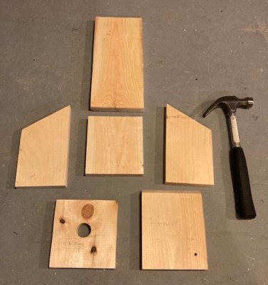 Six pieces of wood, with a hammer next to them