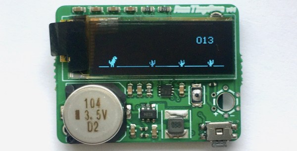 A small PCB with an OLED screen showing a Dinosaur Game