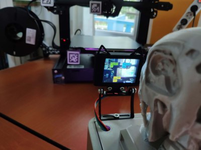 a 3D printed box with a Terminator head watching a camera