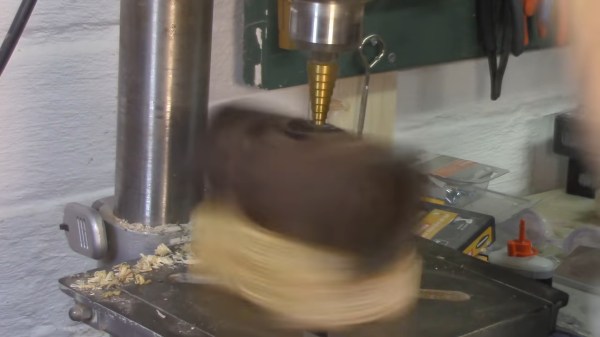 An unfastened piece of pipe in a drill press, rotating away