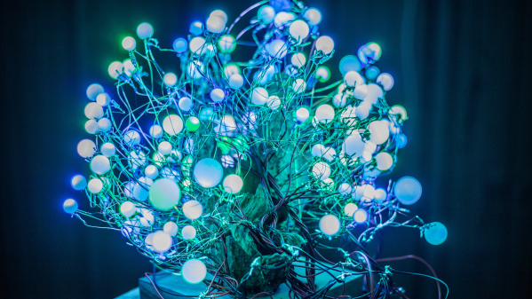 The LED tree itself , filmed in the dark - a myriad of small orbs glowing mictures of green, blue and warm white